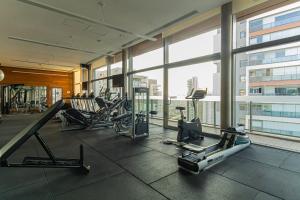 a gym with treadmills and machines in a building at Acrópole Studio - Vaga, Wifi e Piscina no Brooklin in Sao Paulo