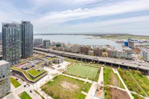 an aerial view of a city with a river and buildings at Stylish Condo Downtown by Rogers Centre in Toronto
