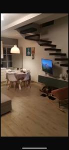 a living room with a dining table and a tv at Casa Rachele in Arezzo
