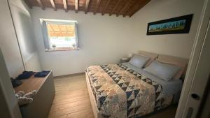 a small bedroom with a bed and a window at Casa Rachele in Arezzo