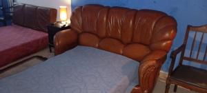 a brown leather chair in a bedroom with a bed at VISIt CASTELO BRANCO in Castelo Branco
