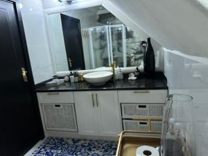 a bathroom with a sink and a mirror at Maison Norelle at Isivuno House in Gillitts +84 photos