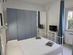 a white bedroom with a bed and a window at Casa Perla in Gaeta +17 photos
