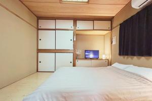 Ένα ή περισσότερα κρεβάτια σε δωμάτιο στο Vacation Rental -裏路地- 202 青い部屋 古馬場町