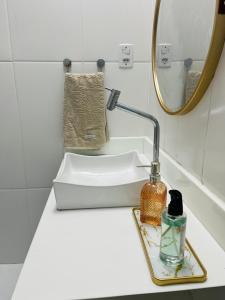a bathroom counter with a sink and a mirror at Casa Urban 56 - Pet Friendly - Vaga - Cama King in Belém +23 photos