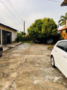 a white car parked in a parking lot at Casa Urban 56 - Pet Friendly - Vaga - Cama King in Belém