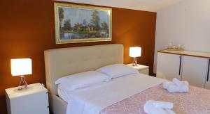 a bedroom with a bed with two towels on it at Villa Desideria in Bribir +40 photos