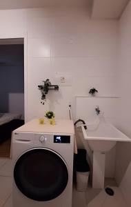 a white bathroom with a sink and a toilet at 803 Ponte laguna 1 dorm. CAMA QUEEN in Sao Paulo