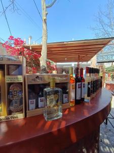a table with many bottles of alcohol on it at HOSPEDAJE WELCOME PARACAS peru in Paracas