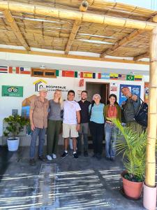 a group of people standing in front of a gas station at HOSPEDAJE WELCOME PARACAS peru in Paracas