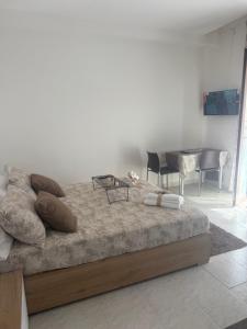 a bed in a room with a table and chairs at Home Sorrento in Torre del Greco +13 photos