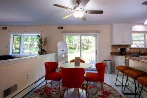 a kitchen with a table and chairs and a ceiling fan at Huge Pocono Dreamhouse 4 bedrooms 12 guests in Blakeslee