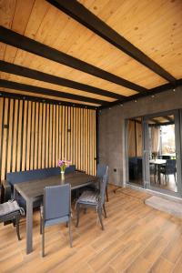 a dining room with a wooden table and chairs at Guzulia in Verkhovyna +75 photos