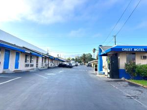 an empty street in a town with a guest motel at The Crest Motel in Corona