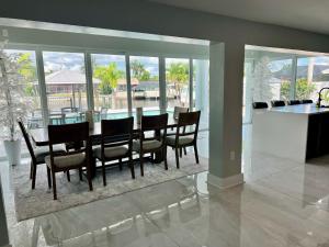 a dining room with a table and some chairs at Luxury Seabreeze Retreat in Fort Myers Beach