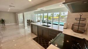 a large kitchen with a sink and a pool at Luxury Seabreeze Retreat in Fort Myers Beach