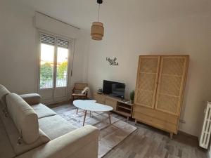 a living room with a couch and a table at NEW Brenta 10 minutes To Duomo M3-15 minutes to Linate - Full furnished APT with AC, Wi-fi and more in Milan