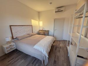 a bedroom with a bed and a book shelf at NEW Brenta 10 minutes To Duomo M3-15 minutes to Linate - Full furnished APT with AC, Wi-fi and more in Milan