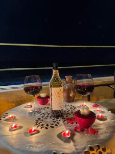 a table with two glasses and a bottle of wine at Balloon Street Cappadocia in Avanos