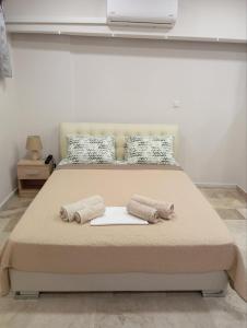 a bedroom with a large bed with two pillows at Elia patra apartment in Patra