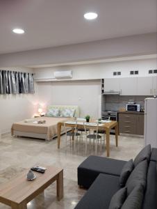 a living room with a bed and a kitchen at Elia patra apartment in Patra