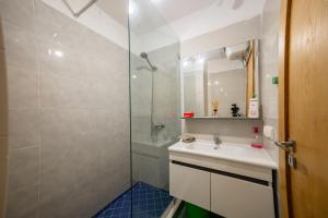 a bathroom with a sink and a shower at Stylish Apartment with Pool Adan Beach Aourir in Aourir +26 photos