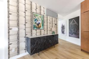 a living room with a wall of art at Ravens Nest - Private Hot Tub in Canmore