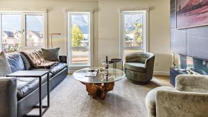 a living room with couches and a coffee table at Ravens Nest - Private Hot Tub in Canmore +42 photos