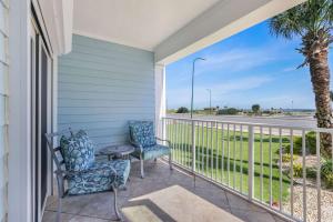 a balcony with two chairs and a table at Grand Caribbean 111 Beach View Condo pool views in Orange Beach