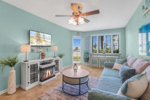 a living room with a couch and a fireplace at Grand Caribbean 111 Beach View Condo pool views in Orange Beach