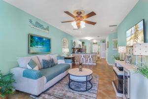 a living room with a couch and a table at Grand Caribbean 111 Beach View Condo pool views in Orange Beach
