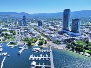an aerial view of a city with a marina at modern private bedroom with private bathroom in a 34-story tower with rooftop lounge in Kelowna +6 photos