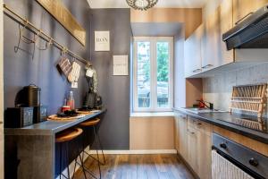 a kitchen with a counter and a table in it at Zenora Loft Hot Tub & Arcade in Downtown in Mulhouse +23 photos