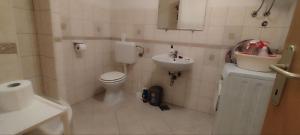 a small bathroom with a toilet and a sink at Nomadic Peace in Šibenik