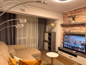 a living room with a couch and a flat screen tv at Brisa Marina in Grao de Castellón