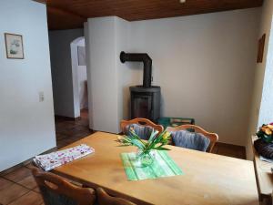 a wooden table with a wood stove in a room at Ferienwohnung Ebser in Todtnau +12 photos