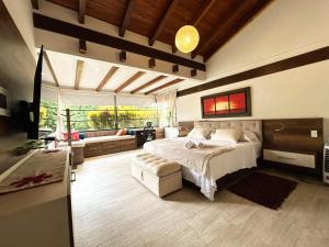 a large bedroom with a bed and a couch at exclusive villa - private pool, luxury and comfort in Armenia +87 photos