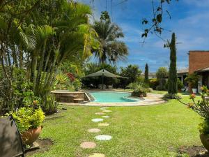 a swimming pool in a yard with trees and plants at exclusive villa - private pool, luxury and comfort in Armenia