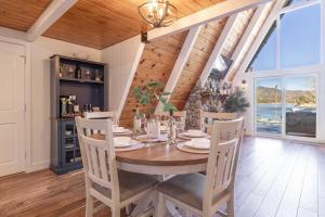 a dining room with a wooden table and chairs at Cove Lakeside Jacuzzi, Central AC, Stunning View in Big Bear Lake