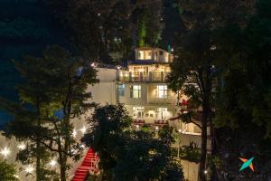 a large white building with a staircase in front of it at Zostel Homes Mussoorie in Mussoorie +20 photos