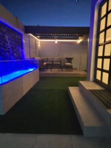 a house with a swimming pool and a patio at night at Willow Brooks in Cape Town