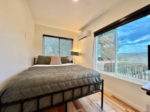 a bedroom with a bed and a large window at Unique Container, Home 20 Acres, Modern Stay in Kelsey
