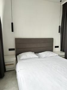 a bedroom with a large white bed with two pillows at Олімпік парк, м Бориспільська 5 хв пішки, генератор на будинку in Kyiv