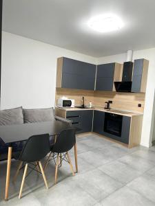 a kitchen with a table and chairs in a room at Олімпік парк, м Бориспільська 5 хв пішки, генератор на будинку in Kyiv