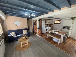 a living room with a couch and a table at La Casuca ONE De Lebeña in Lebena