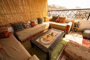 a living room with a couch and a table at Ocean Charm in Tamraght Ouzdar