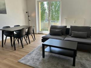 a living room with a couch and a table and chairs at Convenient Apartment for 4 in Bobitz
