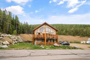 a large house with a deck on a hill at Summit Condo at St. Marys in Ninetyfour