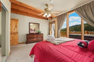 a bedroom with a red bed and a large window at Summit Condo at St. Marys in Ninetyfour