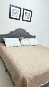 a bed with two pillows on top of it at Sweet Junior de Juliza in Hermosillo